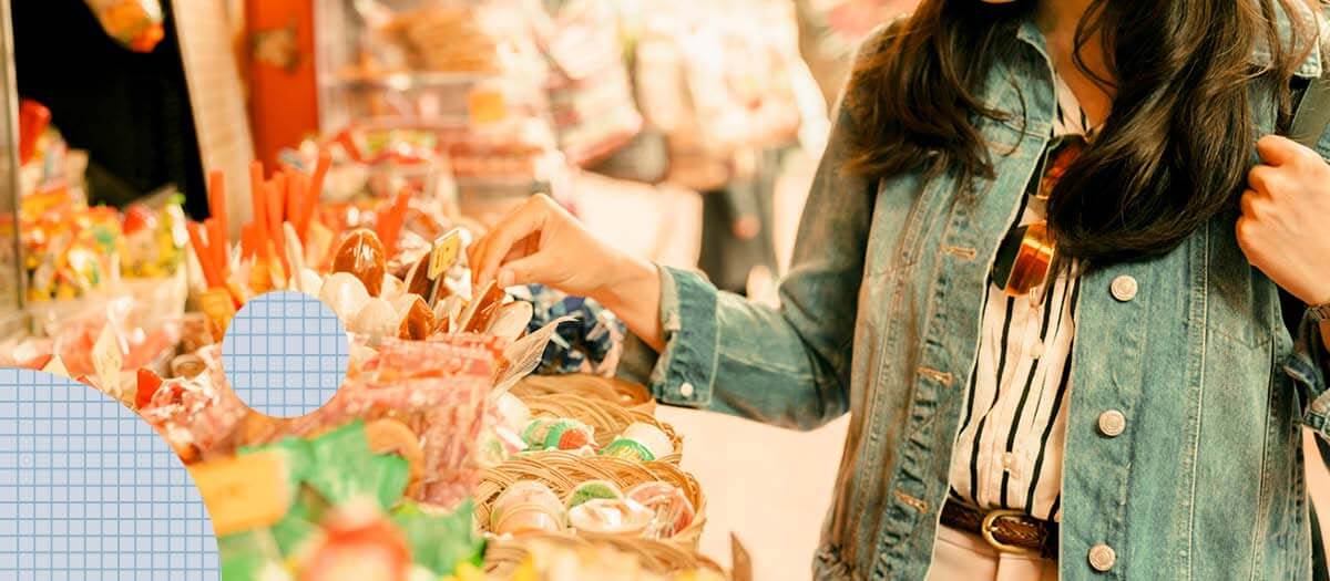 Woman picking out candy at a shop