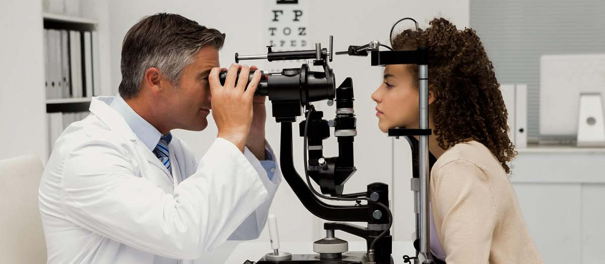 Woman at eye doctor getting eye exam